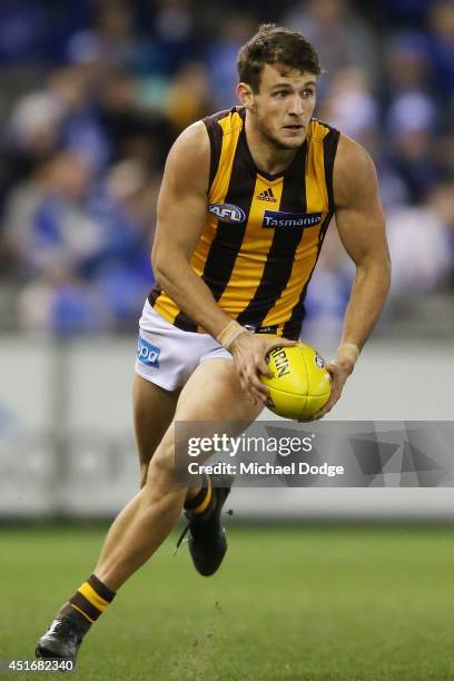 Angus Litherland of the Hawks runs with the ball during the round 16 AFL match between North Melbourne Kangaroos and the Hawthorn Hawks at Etihad...