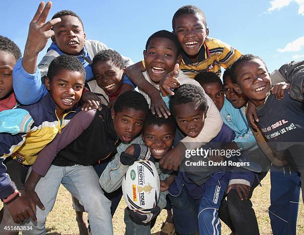 Children hold onto the ball during a visit to the Father Pedro Foundation during the Rugby World Cup Trophy Tour in Madagascar in partnership with...