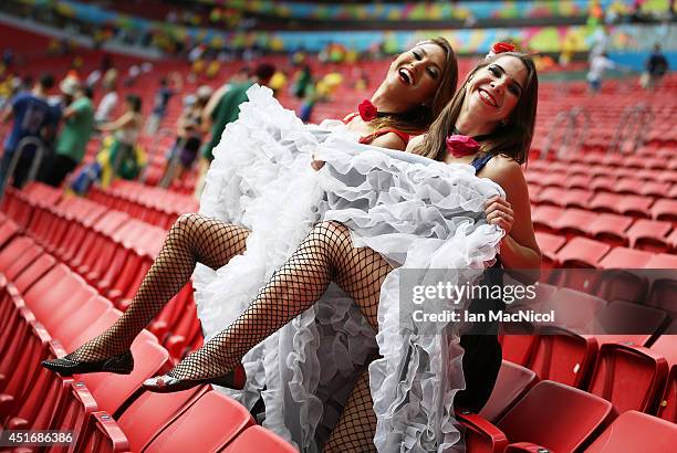 French fans dance a can-can during the 2014 FIFA World Cup Brazil Round of 16 match between France and Nigeria at the Estadio Nacional on June 30,...