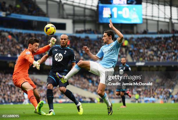 Jesus Navas of Manchester City is closed down by goalkeeper Hugo Lloris and Younes Kaboul of Tottenham Hotspur during the Barclays Premier League...