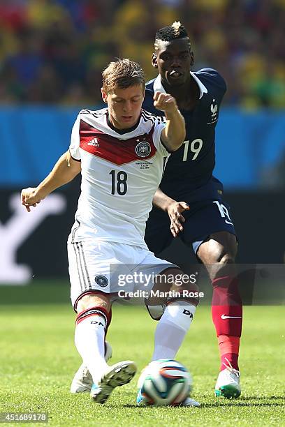 Toni Kroos of Germany controls the ball against Paul Pogba of France during the 2014 FIFA World Cup Brazil Quarter Final match between France and...