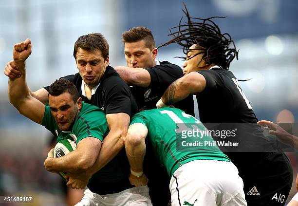 Dave Kearney of Ireland is tackled by Ben Smith, Cory Jane and Ma'a Nonu of the All Blacks during the International match between Ireland and the New...