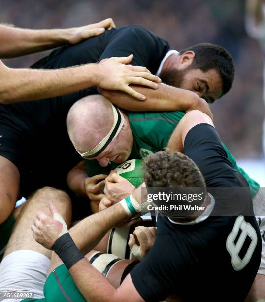 Paul O'Connell of Ireland is tackled by Charlie Faumuina and Kieran Read of the All Blacks during the International match between Ireland and the New...