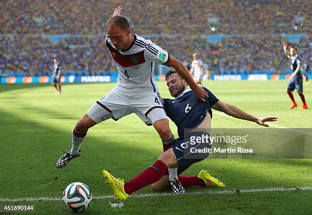 Yohan Cabaye of France tackles Benedikt Hoewedes of Germany during the 2014 FIFA World Cup Brazil Quarter Final match between France and Germany at...