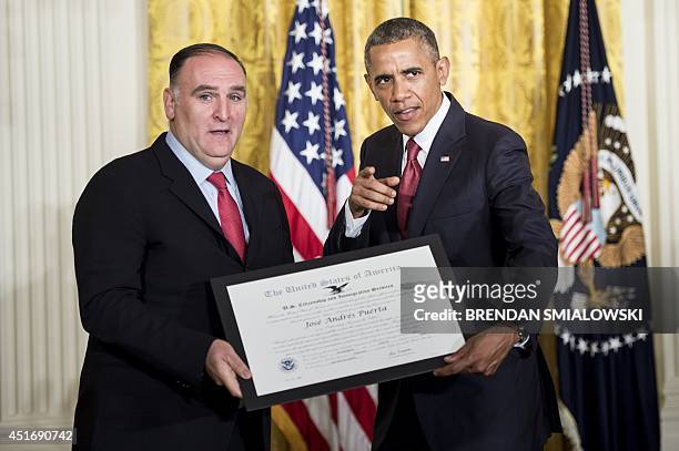 President Barack Obama gives celebrity chef Jose Andres Puerta an award for his charitable deeds during a naturalization ceremony in the East Room of...
