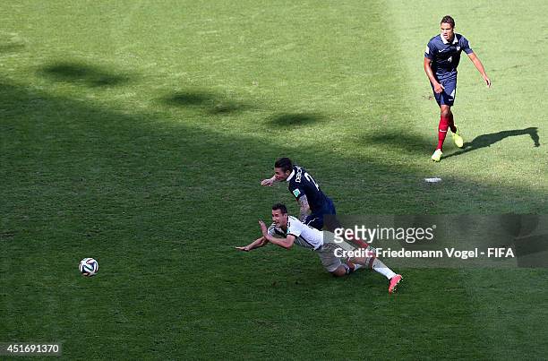Miroslav Klose of Germany and Mathieu Debuchy of France compete for the ball during the 2014 FIFA World Cup Brazil Quarter Final match between France...