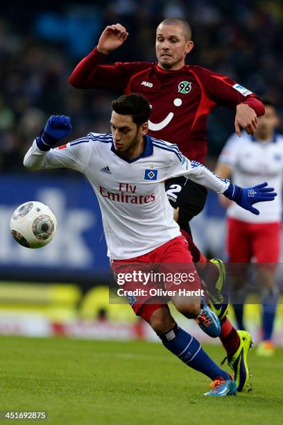 Hakan Calhanoglu of Hamburg and Leon Andreasen of Hannover compete for the ball during the Bundesliga match between Hamburger SV and Hannover 96 at...