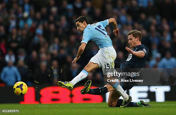 Jesus Navas of Manchester City beats a tackle from Jan Vertonghen of Tottenham Hotspur to score the sixth goal during the Barclays Premier League...