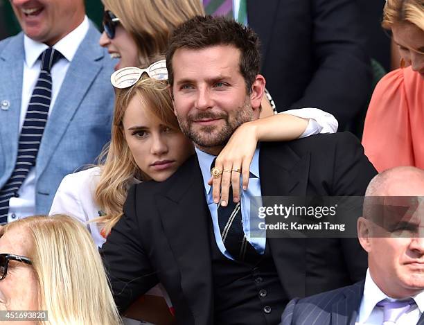 Suki Waterhouse and Bradley Cooper attend the semi-final match between Noval Djokovic and Grigor Dimitrov on centre court at The Wimbledon...