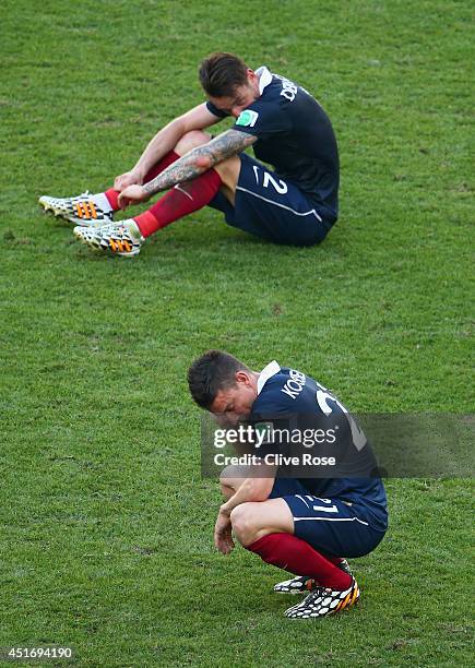 Laurent Koscielny and Mathieu Debuchy of France react after being defeated by Germany 1-0 during the 2014 FIFA World Cup Brazil Quarter Final match...