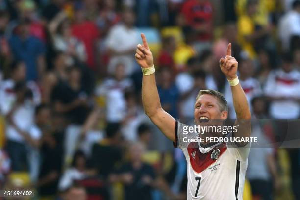 Germany's midfielder Bastian Schweinsteiger celebrates after winning the quarter-final football match between France and Germany 1-0 at the Maracana...