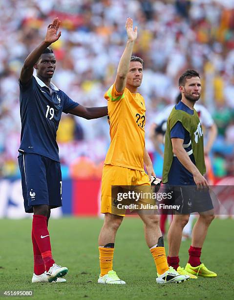 Paul Pogba and Mickael Landreau of France acknowledge the fans after being defeated by Germany 1-0 during the 2014 FIFA World Cup Brazil Quarter...