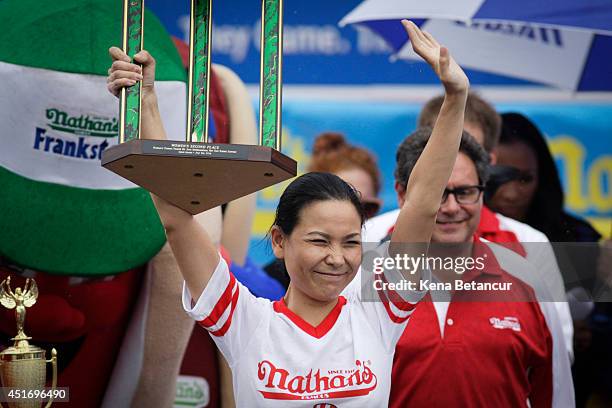 Sonya "The Black Widow" Thomas celebrates her second place finish in the women's division of the 98th annual Nathan's Famous Hot Dog Eating Contest...