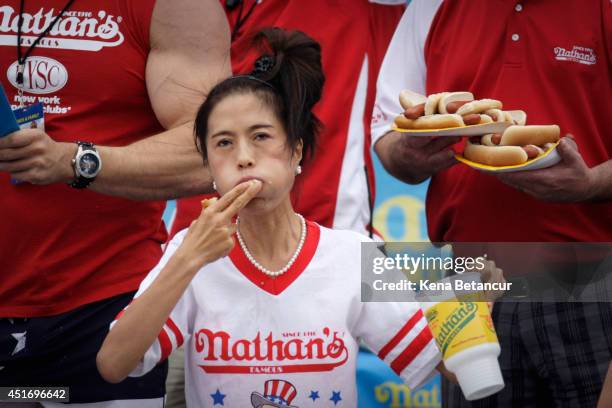 Juliet Lee competes in the women's division of the Nathan's Famous Hot Dog Eating Contest at Coney Island on July 4, 2014 in the Brooklyn borough of...