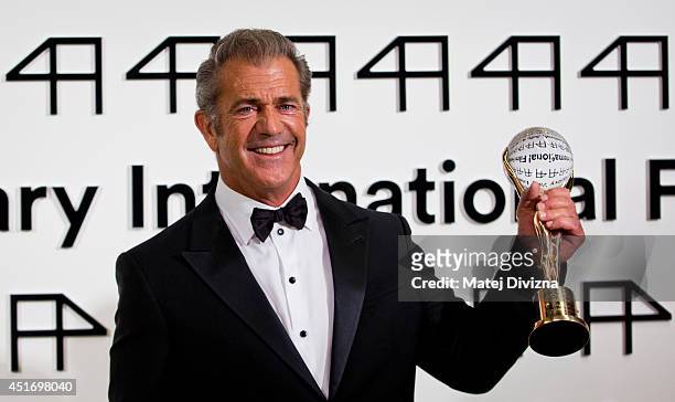 Actor Mel Gibson poses with the Crystal Globe for Outstanding Artistic Contribution to World Cinema at the opening ceremony of the 49th Karlovy Vary...