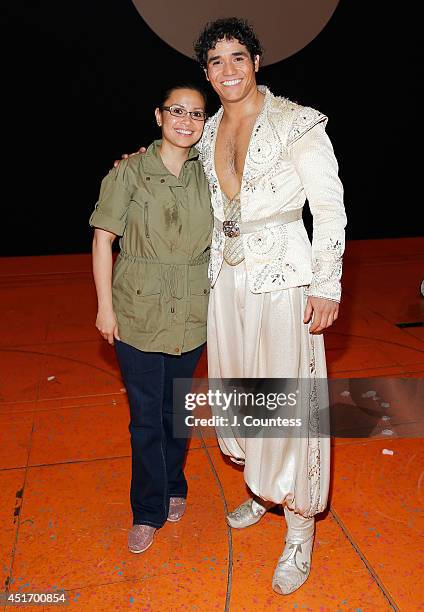 Singer Lea Salonga poses with actor Adam Jacobs backstage following a performance of "Aladdin" at New Amsterdam Theatre on July 3, 2014 in New York...