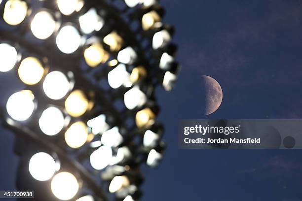 The moon is seen next to the floodlights during the Natwest T20 Blast match between Kent Spitfires and Hampshire at St. Lawrence Ground on July 4,...