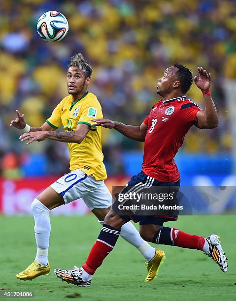 Neymar of Brazil and Juan Camilo Zuniga of Colombia compete for the ball during the 2014 FIFA World Cup Brazil Quarter Final match between Brazil and...