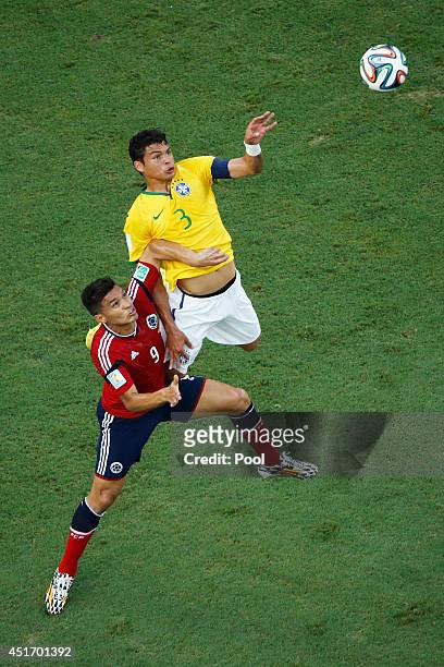 Teofilo Gutierrez of Colombia and Thiago Silva of Brazil go up for a header during the 2014 FIFA World Cup Brazil Quarter Final match between Brazil...