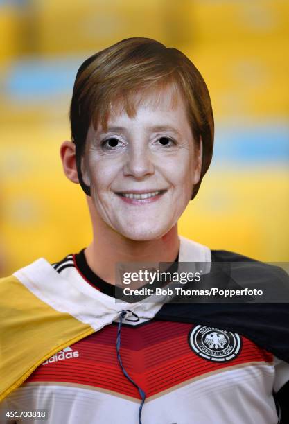 Fan wearing a face mask of German Chancellor Angela Merkel prior to the 2014 FIFA World Cup Brazil Quarter Final match between France and Germany at...