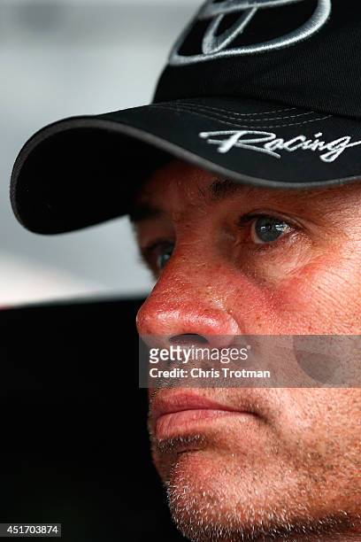 Michael Waltrip, driver of the RoyalTeakCollection.com Toyota, sits in his car during qualifying for the NASCAR Sprint Cup Series Coke Zero 400 at...