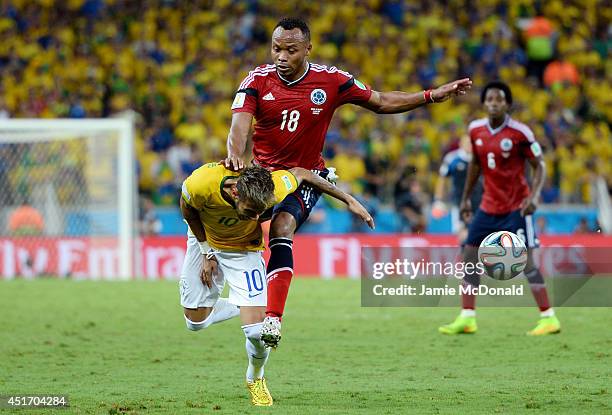 Neymar of Brazil is challenged by Juan Camilo Zuniga of Colombia during the 2014 FIFA World Cup Brazil Quarter Final match between Brazil and...