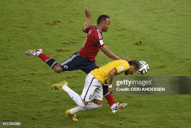 Colombia's defender Juan Camilo Zuniga fouls Brazil's forward Neymar during the quarter-final football match between Brazil and Colombia at the...