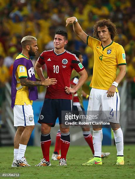 Dani Alves and David Luiz of Brazil console James Rodriguez of Colombia after Brazil's 2-1 win during the 2014 FIFA World Cup Brazil Quarter Final...