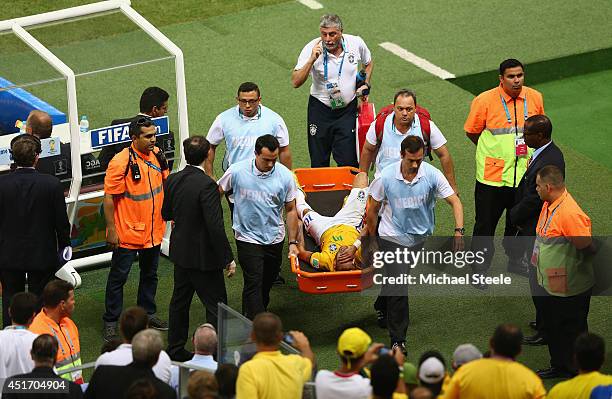 Neymar of Brazil is stretchered off the field after a challenge during the 2014 FIFA World Cup Brazil Quarter Final match between Brazil and Colombia...