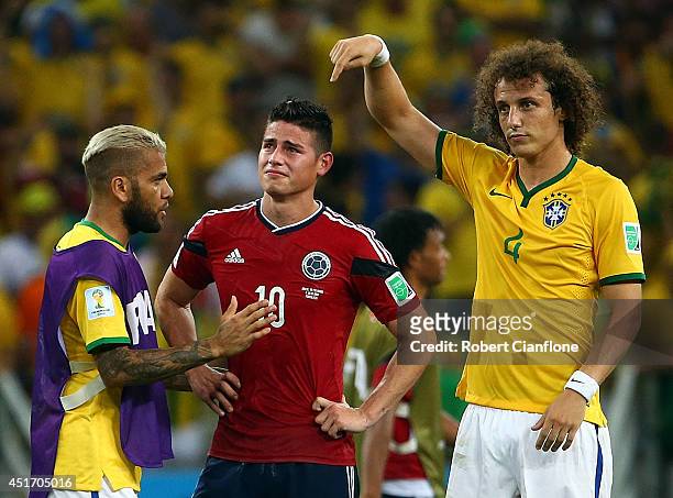 Dani Alves and David Luiz of Brazil console James Rodriguez of Colombia after Brazil's 2-1 win during the 2014 FIFA World Cup Brazil Quarter Final...