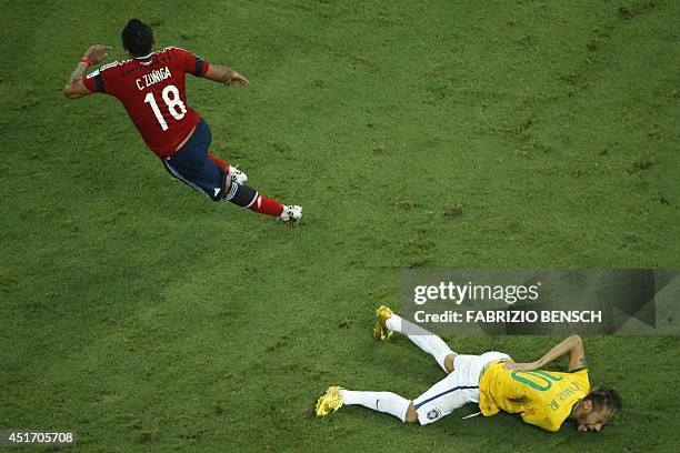 Brazil's forward Neymar reacts on the ground after being injured following a foul by Colombia's defender Juan Camilo Zuniga during the quarter-final...
