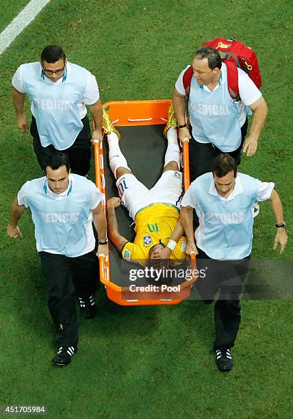 Neymar of Brazil is stretchered off the pitch after a challenge during the 2014 FIFA World Cup Brazil Quarter Final match between Brazil and Colombia...