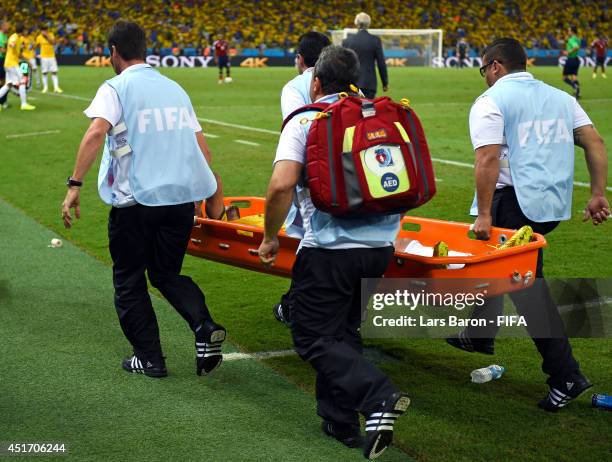 Neymar of Brazil is taken off the pitch by a stretcher during the 2014 FIFA World Cup Brazil Quarter Final match between Brazil and Colombia at...