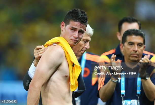 James Rodriguez of Colombia is consoled by head coach Jose Pekerman after the 1-2 defeat in the 2014 FIFA World Cup Brazil Quarter Final match...