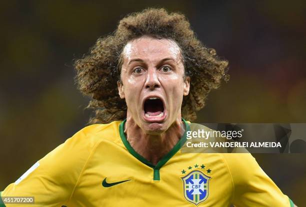 Brazil's defender David Luiz celebrates scoring during the quarter-final football match between Brazil and Colombia at the Castelao Stadium in...