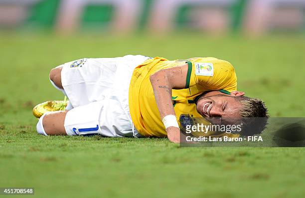 Neymar of Brazil lies injured during the 2014 FIFA World Cup Brazil Quarter Final match between Brazil and Colombia at Estadio Castelao on July 4,...