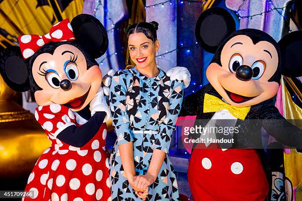 In this handout photo provided by Disney Parks, singer Katy Perry poses with Minnie Mouse and Mickey Mouse at Disney's Hollywood Studios at Walt...