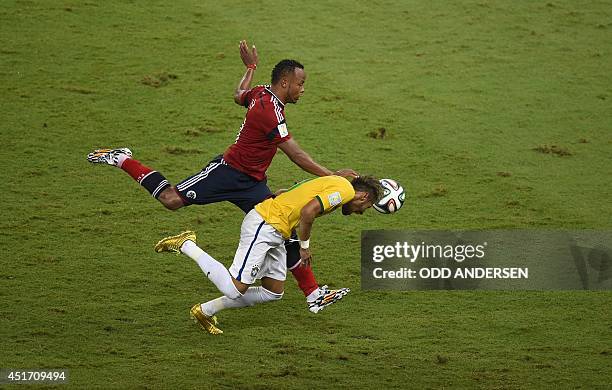 Colombia's defender Juan Camilo Zuniga challenges Brazil's forward Neymar during the quarter-final football match between Brazil and Colombia at the...