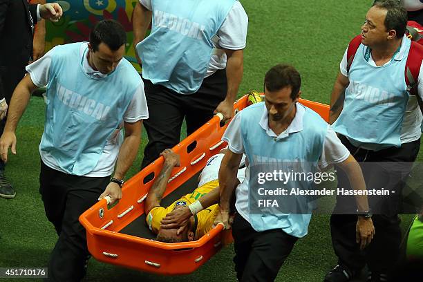 Neymar of Brazil is taken off the pitch by a stretcher during the 2014 FIFA World Cup Brazil Quarter Final match between Brazil and Colombia at...