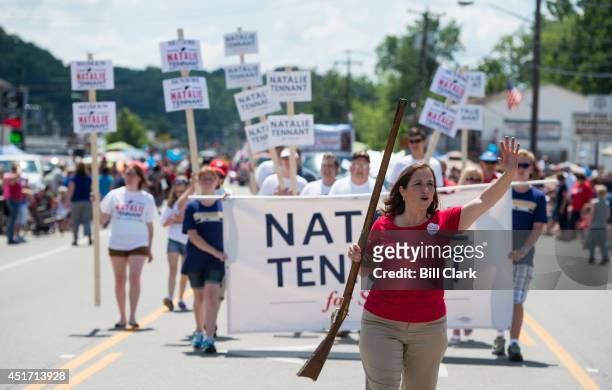 Senate candidate West Virginia Secretary of State Natalie Tennant marches with her musket in the Ripley 4th of July Parade in Ripley, W. Va., on July...