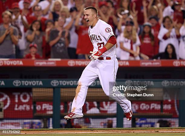 Mike Trout of the Los Angeles Angels of Anaheim celebrates as he runs home after hitting a game winning walk off home run to lead off the ninth...