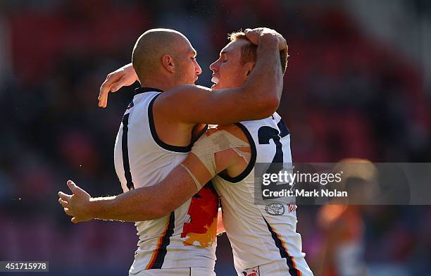 James Podsiadly and Tom Lynch of the Crows embrace after Podsiadly kicked a goal during the round 16 AFL match between the Greater Western Giants and...