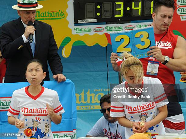 Sonya Thomas and Miki Sudo competes in the Women's Division at the 2014 Nathan's Famous 4th July International Hot Dog Eating Contest at Coney Island...