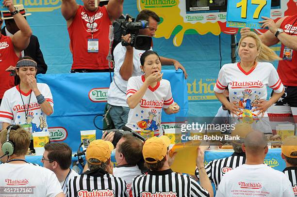 Sonya Thomas , Michelle Lesko and Miki Sudo competes in the Women's Division at the 2014 Nathan's Famous 4th July International Hot Dog Eating...