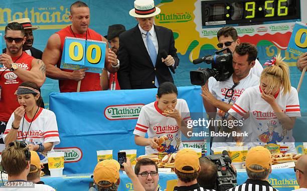 Sonya Thomas , Michelle Lesko and Miki Sudo competes in the Women's Division at the 2014 Nathan's Famous 4th July International Hot Dog Eating...