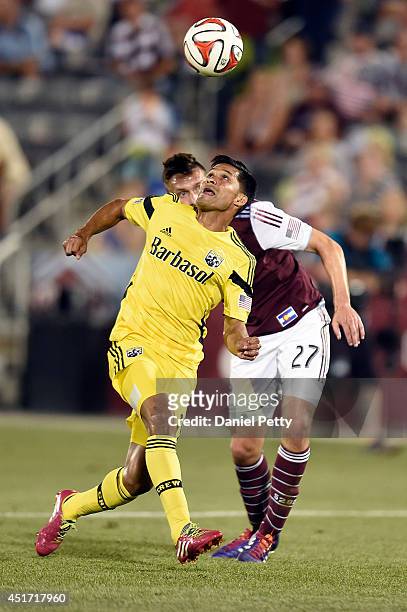 Jairo Arrieta of the Columbus Crew tries to control a ball against Shane O'Neill of the Colorado Rapids during an MLS game at Dick's Sporting Goods...
