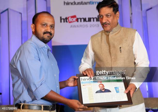 Chief Minister Shri Prithviraj Chauhan felicitates Pankaj Joshi during the HT for Mumbai Awards 2013 at Hotel Four Seasons, Worli on November 22,...