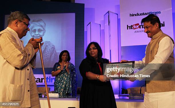 Sharada Dwivedi's husband and daughter receive award on behalf of her from Chief Minister Shri Prithviraj Chauhan during the HT for Mumbai Awards...