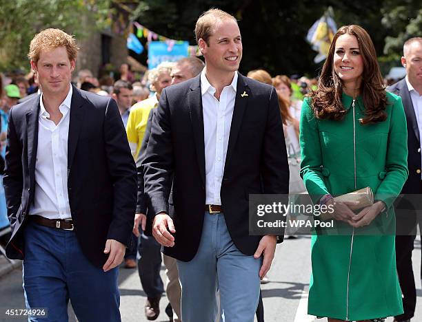 Prince Harry, Prince William, Duke of Cambridge and Catherine, Duchess of Cambridge walk along the street to celebrate the start of the Tour de...