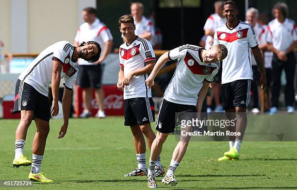 Sami Khedira of Germany jokes with team mate Andre Schuerrle during the German national team training at Campo Bahia on July 5, 2014 in Santo Andre,...